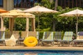 Comfortable chaise lounges by the swimming pool