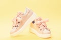 Comfortable footwear concept. Footwear for girls or women decorated with pearl beads. Pair of pale pink female sneakers Royalty Free Stock Photo