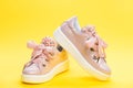 Comfortable footwear concept. Footwear for girls or women decorated with pearl beads. Pair of pale pink female sneakers