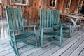 Green rocking chairs on porch