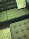 Comfortable green sofa with foot stool