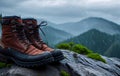 Comfortable hiking Pair of boots on a rock against backdrop of rainy day in mountain