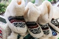 Comfortable home slippers. Selling warm cozy woolen shoes for home at a Ukrainian fair. Local craftsmanship for tourists. Present