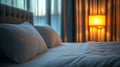 A comfortable hotel bed features cozy white bedding and soft pillows Royalty Free Stock Photo