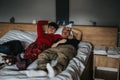 Casual couple relaxing at home, lounging together on a cozy bed Royalty Free Stock Photo