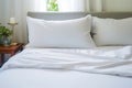 a comfortable and inviting bed with crisp white sheets and a fluffy pillow. Comfort and relax concept. Royalty Free Stock Photo