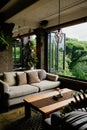 Comfortable lounge setting with sofa and wooden table overlooking greenery.