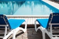 Comfortable loungers at clean swimming on sunny day