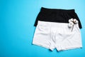 Comfortable men`s underwear and cotton flowers on blue background, flat lay. Space for text Royalty Free Stock Photo