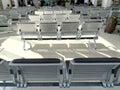 comfortable metal rows of seats in bright airport lounge, Airport waiting room, concept passenger traffic, delay, flight Royalty Free Stock Photo