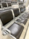 comfortable metal rows of seats in bright airport lounge, Airport waiting room, concept passenger traffic, delay, flight Royalty Free Stock Photo