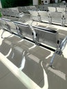 comfortable metal rows of seats in bright airport lounge, Airport waiting room, concept passenger traffic, delay, flight Royalty Free Stock Photo