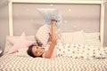 Comfortable pillow. Girl smiling child lay bed star pattern pillows and plaid bedroom. Bedclothes for children. Girl kid Royalty Free Stock Photo