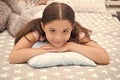 Comfortable pillow. Girl smiling happy child lay on bed with star pattern pillows and cute plaid in her bedroom Royalty Free Stock Photo