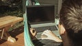 Comfortable place for working. A man is working in hammock near country house Royalty Free Stock Photo