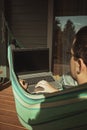 Comfortable place for working. A man is working in hammock near country house Royalty Free Stock Photo