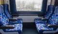 Comfortable seats in empty train compartment with window. Modern train interior. Royalty Free Stock Photo