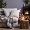 Comfortable shite sofa with cushions and plaid near side table with burning candles. Scandinavian interior design