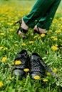 Comfortable Shoes Concept. Business Woman Changing Shoes Work Heels From High Heel To Comfortable Sneakers On Green Grass