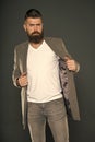Comfortable simple coat. Serious concentrated man. Caucasian man with brutal appearance. Bearded man with moustache and