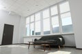 Comfortable sofa and table near large window with white roller blinds indoors Royalty Free Stock Photo