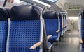 comfortable soft blue seats with headrests in half-empty train car in Germany, concept of long-distance travel, ticket for Royalty Free Stock Photo