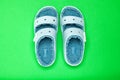 Comfortable, soft Crocs, foam clog shoes with faux fur on green background