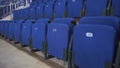 Comfortable soft empty blue seats in the arena of a sports facility. Rows of armchairs.