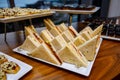 Comfortable triangular sandwiches on the banquet table Royalty Free Stock Photo