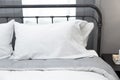 Comfortable white and grey pillow on bed Royalty Free Stock Photo