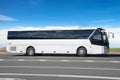 Comfortable white tourist bus on the highway in travel