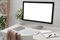 Comfortable workplace at home. Modern computer with blank screen and notebook on white desk. Mockup for design Royalty Free Stock Photo