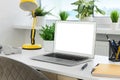 Comfortable workplace at home. Modern laptop with blank screen and lamp on white desk. Mockup for design Royalty Free Stock Photo