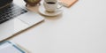 Comfortable workplace with laptop computer, coffee cup and office supplies on white wooden desk Royalty Free Stock Photo