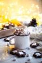 Comforting Christmas food, mug of hot cocoa with marshmallow and cookies with cozy lights Royalty Free Stock Photo