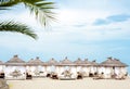 Comfotable tents with canopy and sofas on vip beach seascape Royalty Free Stock Photo