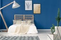 Blue walls and light bedding Royalty Free Stock Photo