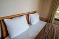 Comfy white pillows on mattress in luxury hotel double bedroom