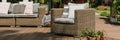 Wicker armchair with pillows on wooden terrace of trendy s