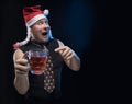 Comic actor man in cap with braids with a glass of beer, in anticipation of Christmas and New Year Royalty Free Stock Photo