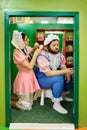 Comic baby man and woman playing in barbershop