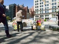 Comic book seller talking next to Flatiron building, new york