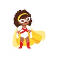 Comic brave girl kid with curly hair in superhero white and red costume, mask and yellow cloak, standing on legs wide Royalty Free Stock Photo