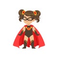 Comic brave girl kid in superhero black costume with star, mask and developing in the wind red cloak, standing on legs Royalty Free Stock Photo