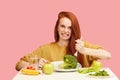 Comic grimacing funny woman on healthy food eating with broccoli and vegetables Royalty Free Stock Photo