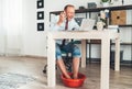 Comic modern home office situation. Businessman have emotional video call chatting on laptop and soaring his feet in Foot hot Royalty Free Stock Photo