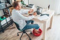 Comic modern home office situation. Businessman have a video call chatting on laptop and soaring his feet in Foot hot Bath under Royalty Free Stock Photo