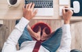 Comic modern office table top view shot. Businessman typing on laptop keyboard, using a PC mouse and soaring his feet in Foot hot Royalty Free Stock Photo