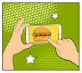 Comic phone with halftone shadows and Hamburger. Hand holding smartphone with buy online internet shopping. Fast food background.