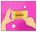 Comic phone with halftone shadows and Hamburger. Hand holding smartphone with buy online internet shopping. Fast food background.